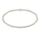 Bracelet with gold and light blue beads on a white background