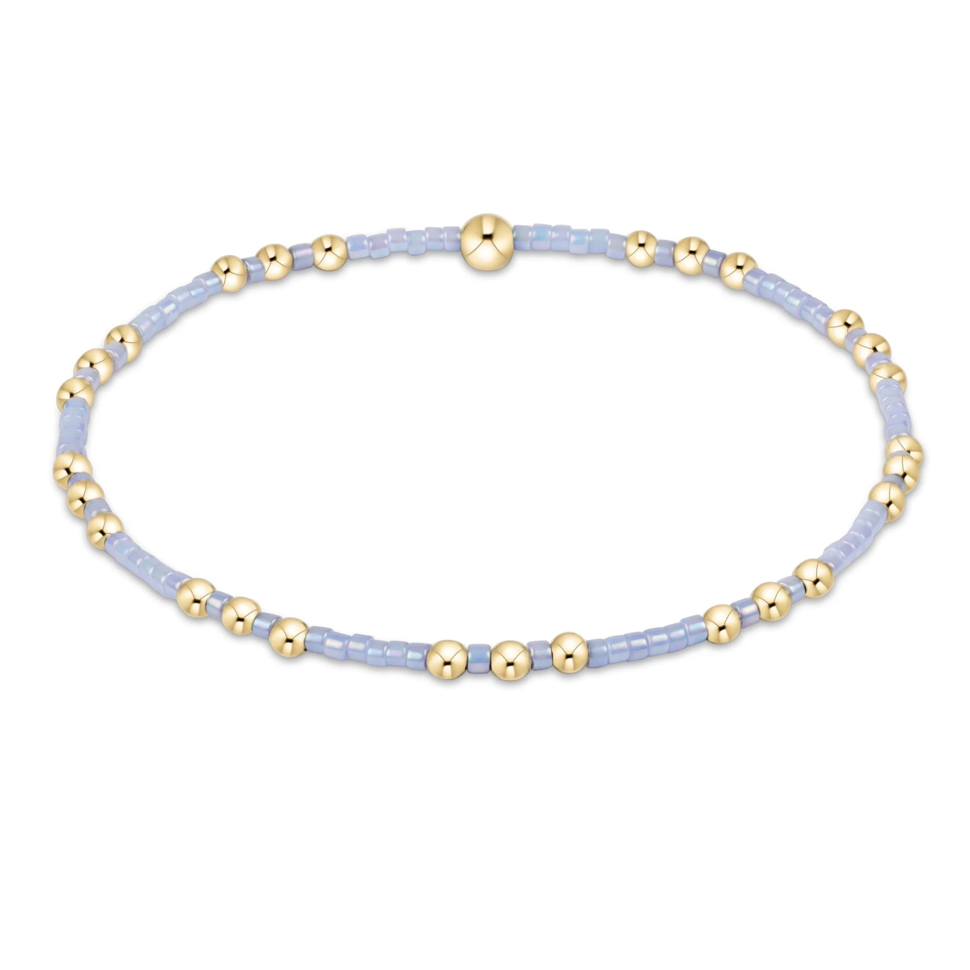 Bracelet with gold and light blue beads on a white background