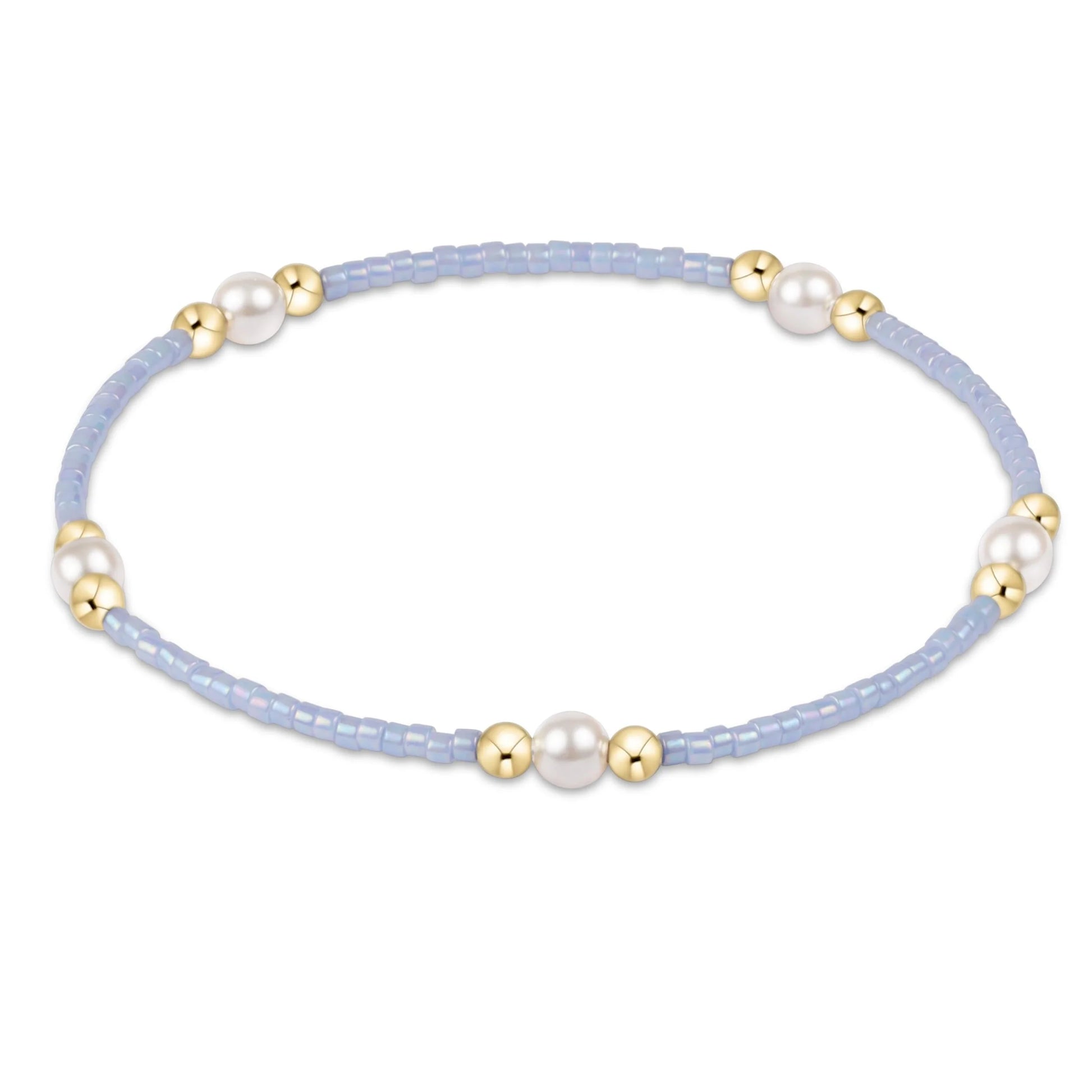 Bracelet with light blue beads, gold accents, and pearls on a white background